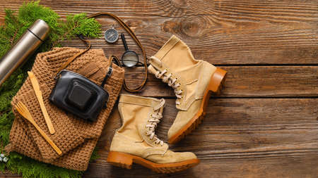 Composition with items and clothes for hiking on wooden backgroundの写真素材