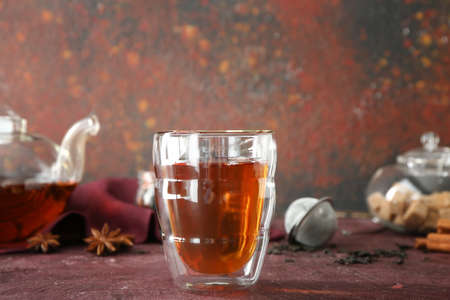 Glass of hot aromatic tea on grunge backgroundの写真素材
