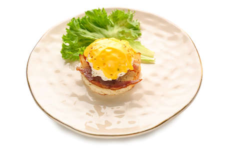 Plate with tasty egg Benedict on white backgroundの写真素材