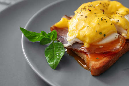 Plate with tasty egg Benedict on table, closeupの写真素材