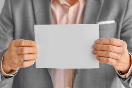 Man with blank paper sheet, closeupの写真素材