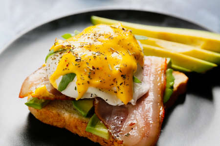 Plate with tasty egg Benedict on table, closeup