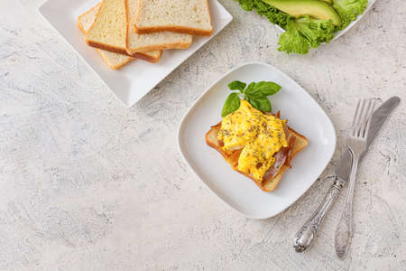 Composition with tasty egg Benedict on table