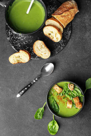 Bowls with tasty spinach soup on dark backgroundの写真素材