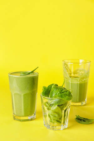 Glasses of healthy spinach smoothie on color backgroundの写真素材