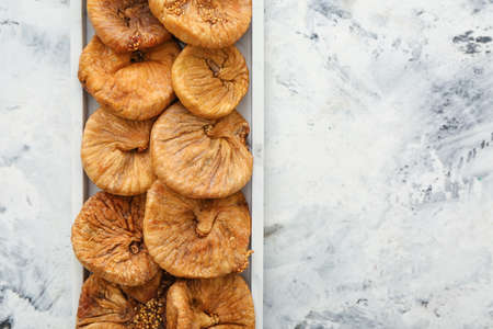 Plate with dried figs on light backgroundの写真素材