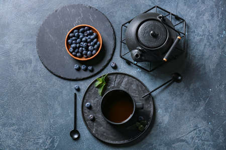 Composition with cup of hot blueberry tea on dark backgroundの写真素材