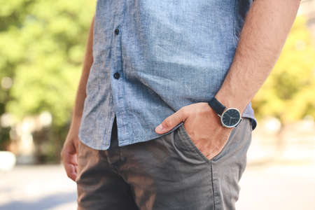 Young man with stylish wristwatch outdoorsの写真素材