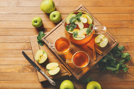 Composition with cups of hot fruit tea on wooden backgroundの写真素材