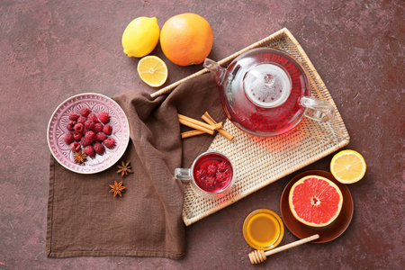 Composition with cup of hot fruit tea on grunge background