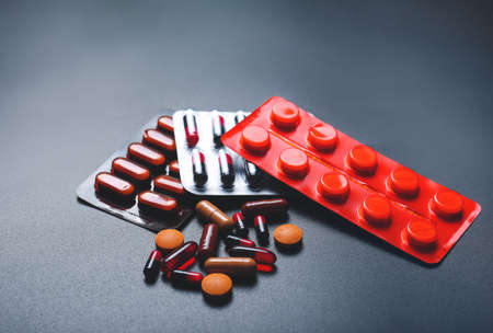 Different pills on dark backgroundの写真素材
