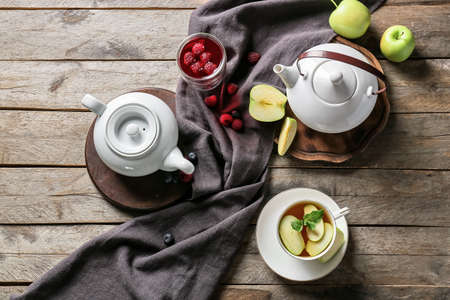 Composition with cups of hot fruit tea on wooden backgroundの写真素材
