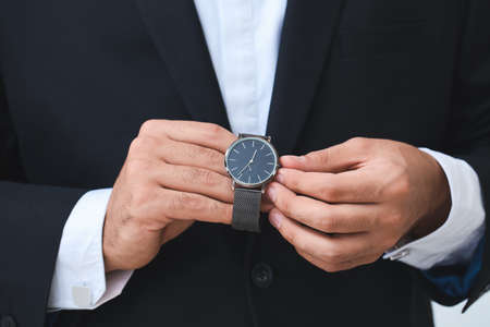 Young businessman with stylish wristwatch, closeupの写真素材