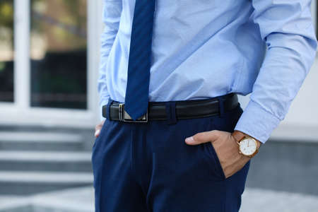 Young businessman with stylish wristwatch outdoorsの写真素材