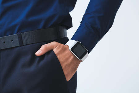 Handsome businessman with smart watch on light backgroundの写真素材