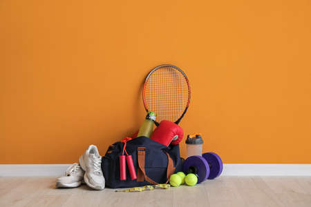 Set of sports equipment on floor near color wallの写真素材
