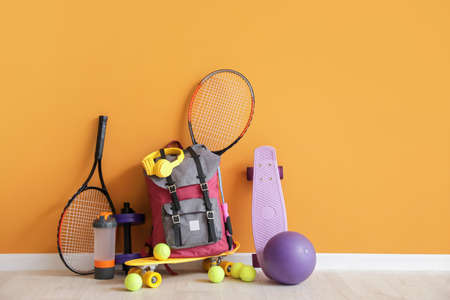 Set of sports equipment on floor near color wallの写真素材