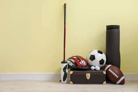 Set of sports equipment on floor near color wallの写真素材