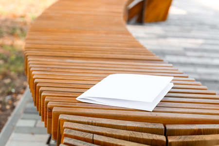 Blank magazine on bench in parkの写真素材