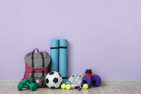 Set of sports equipment on floor near color wallの写真素材