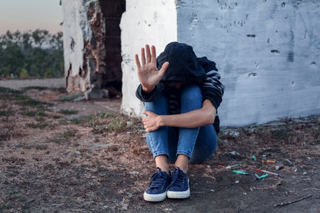 Female junkie showing STOP gesture outdoorsの写真素材