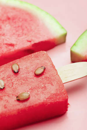Tasty watermelon ice-cream on color background, closeup