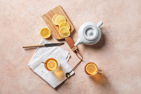 Composition with cups of hot healthy tea on color backgroundの写真素材