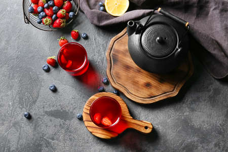 Composition with glasses of hot fruit tea on dark background