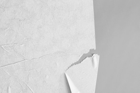 Blank creased paper sheet on gray backgroundの写真素材