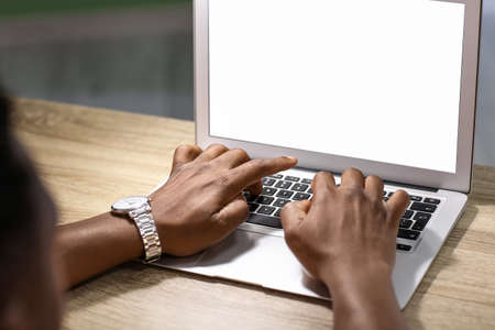 African-American man working on laptop at home, closeup