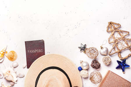 Composition with Christmas decor, hat and passport on white backgroundの写真素材