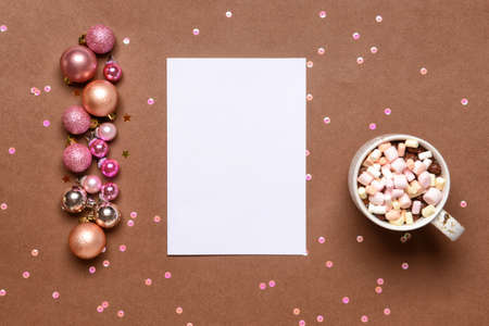 Beautiful Christmas decorations with empty card and cup of cacao drink on color backgroundの写真素材