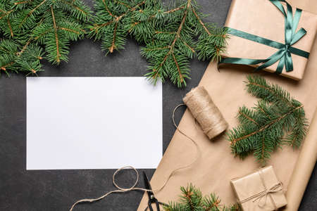 Beautiful Christmas gifts with empty card on dark backgroundの写真素材
