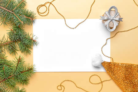 Beautiful Christmas decorations with empty card on color backgroundの写真素材
