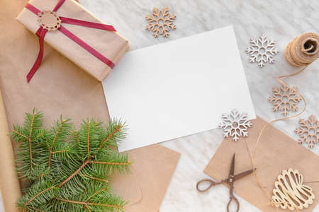 Beautiful Christmas decorations with empty card, gift and envelope on white backgroundの写真素材