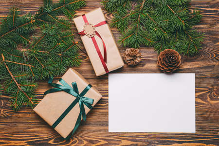 Beautiful Christmas gifts with empty card on wooden backgroundの写真素材