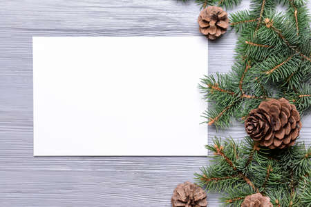 Beautiful Christmas decorations with empty card on wooden backgroundの写真素材