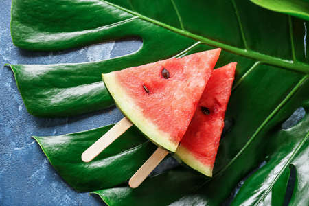 Slices of ripe watermelon on green leaf