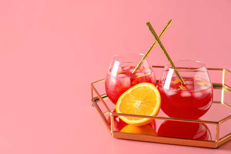 Tray with glasses of fruit ice tea on color backgroundの写真素材