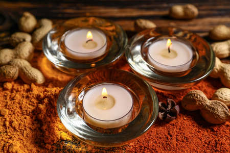 Burning candles with spices and nuts for celebration of Divaly on tableの写真素材