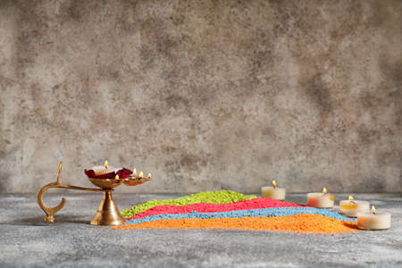 Festive composition with diya lamp for celebration of Divaly on gray backgroundの写真素材
