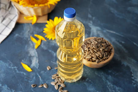 Plastic bottle of sunflower oil on color backgroundの写真素材