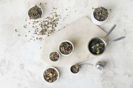 Composition with bowls of dry fruit tea on light backgroundの写真素材