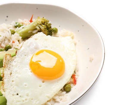 Plate with tasty egg, vegetables and rice on white backgroundの写真素材