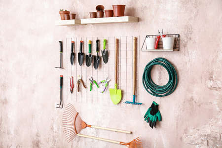 Different gardening supplies hanging on wallの写真素材