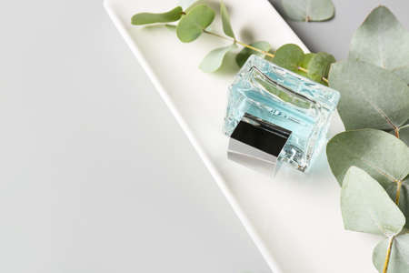 Composition with bottle of perfume on light backgroundの写真素材