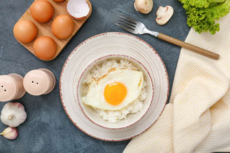 Bowl with tasty egg and rice on dark backgroundの写真素材