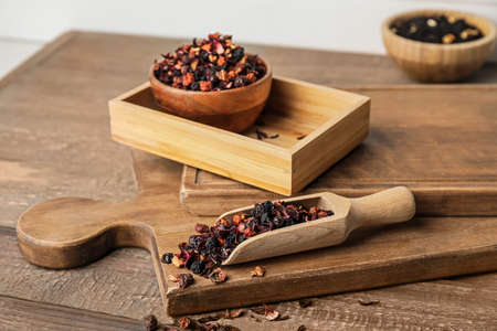 Scoop with dry fruit tea on wooden backgroundの写真素材