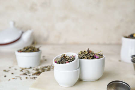 Bowls with dry fruit tea on light backgroundの写真素材