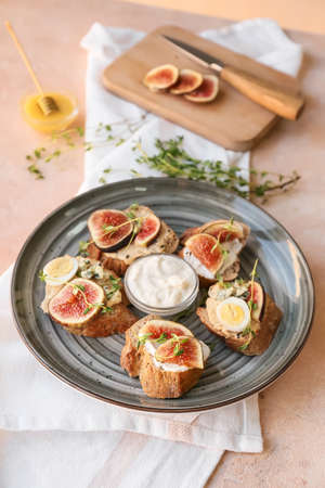Tasty sandwiches with fig on color backgroundの写真素材